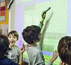 Children in class with a digital blackboard 
